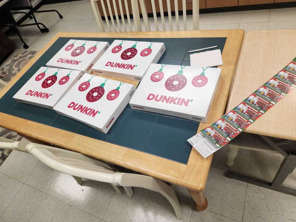 table full of dunkin donuts and lottery tickets